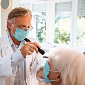 Close up of a doctor doing an eye exam on his patient