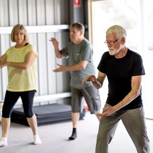 Group of seniors in qi gong class exercising in an active retirement lifestyle. 