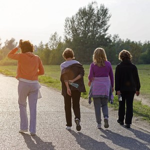 Female Friends over fifty exercising outdoors.