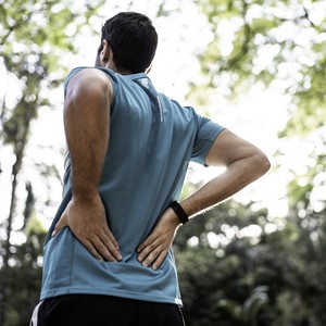 Sportsman feeling backache at a park