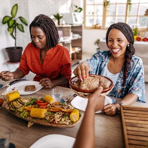 Women laughing and enjoying a meal 