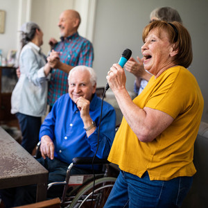 Group of Senior people having fun at Karaoke party