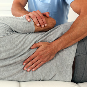 Chiropractic treatment, Back pain relief. Physiotherapy for senior male patient, Kinesiology