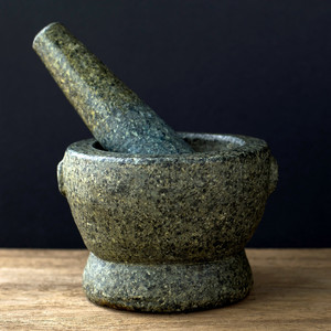Stone Mortar on the wooden table, Black background 