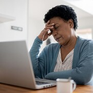 headache woman in front of computer