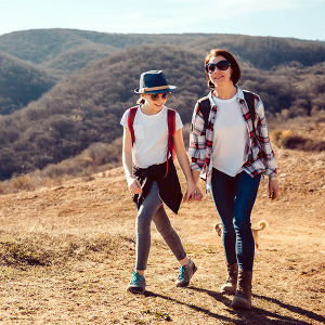 two people walking in woods