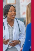 A seated medical provider discussing a clinical trial with a patient.