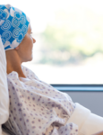 A patient lying on a hospital table and looking outside the window.