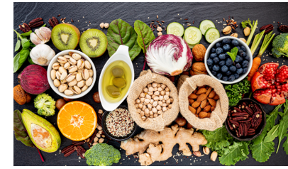 A sampling of healthy foods, including nuts, fuits, vegetables, and ginger root 