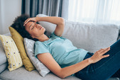 woman lying down on couch