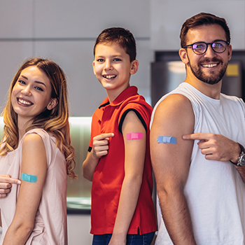 group of people with bandages on their arms after vaccination