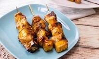 Image of three chicken skewers on a plate.