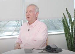 Dr. Goff sits at a table with a blood pressure monitor and cuff. 