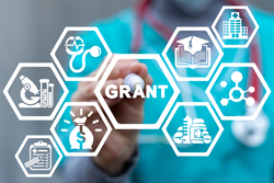 Hexagonal vector with scientific and medical images as well as the word “grant” with a blurred photo of a healthcare provider in the background