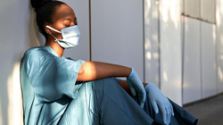 Female doctor sitting down with her eyes closed