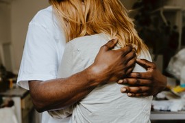  Close-up of adult man and woman embracing.