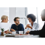 Four professionals talking over coffee.