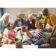 A group of friends share laughter over the contents shown on a tablet.