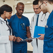 group of medical professionals looking at a clipboard
