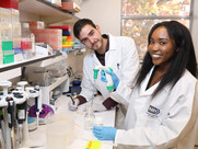 photo of two trainees in the lab smiling