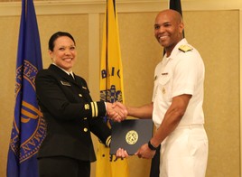 LT Adelaida Rosario receiving her USPHS graduation certificate from U.S. Surgeon General Jerome Adams