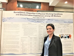 Dr. Rada Dagher standing in front of poster 