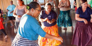 Women hula dancing in a classroom