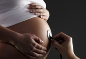 Pregnant woman receiving physical exam