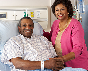 African American patient with his wife at bedside