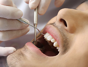 Asian man receiving dental care