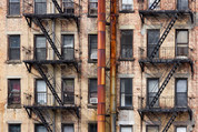 Old apartment building with rusted metal pipes