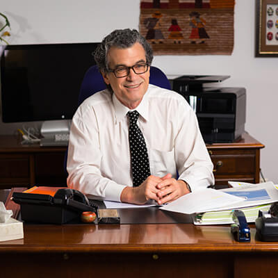 Eliseo J. Pérez-Stable, M.D. at desk