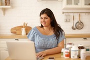 Woman at computer with supplements