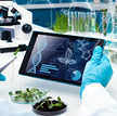 Scientist with plants and a tablet