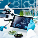 Scientist with tablet and plants