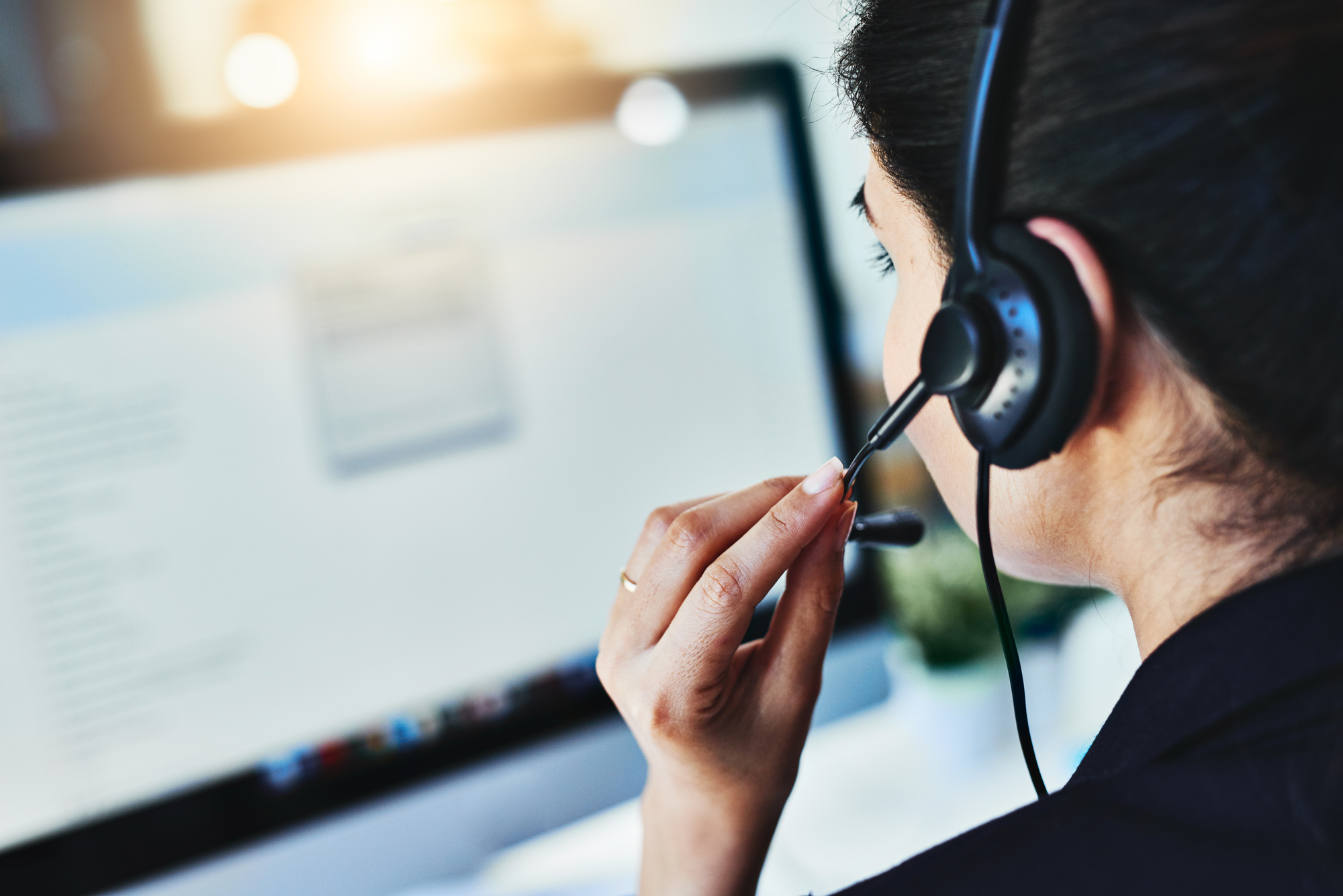 Image of woman answering calls in a call center