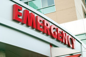 Photo of a hospital emergency room sign with red letters that say 