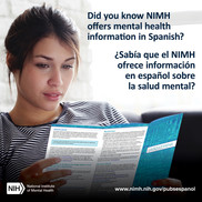 A dark haired young woman reads an NIMH brochure in Spanish