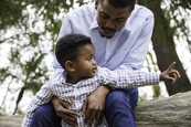 Father sitting and talking to his toddler