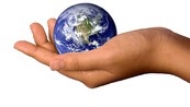 A hand holding a world globe.