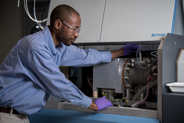 Man stands at a mass spectrometer