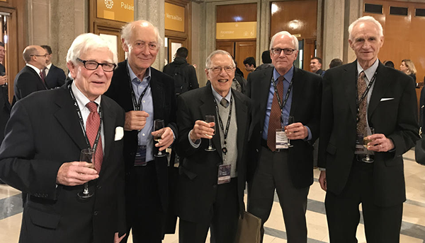 Five scientists celebrating at SI redefinition vote.