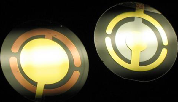 Two circular disks are quartz crystal resonators with front and back electrodes.