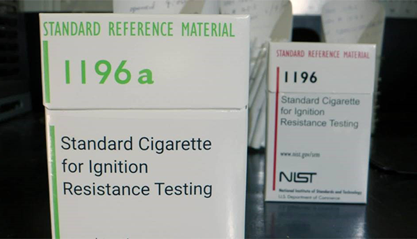 A box of cigarettes is labeled: Standard Cigarette for Ignition Resistance Testing