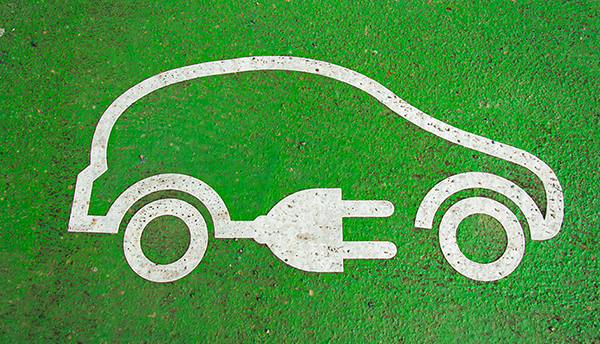 White outline on green background shows car silhouette with charging plug.