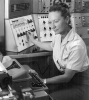 Ethel Marden sits at the control panel of the SEAC computer in a historical photo.