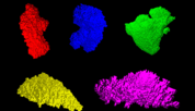 Five particles of moon dust look like brightly colored rocks on a black background. 