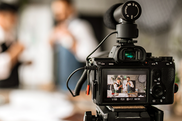 video camera filming workers in a manufacturing facility