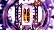 Rectangular device in circular casing is quantum computer module.