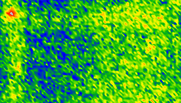 Mostly green image with red, yellow and blue shows resonator vibrations mapped on a surface.